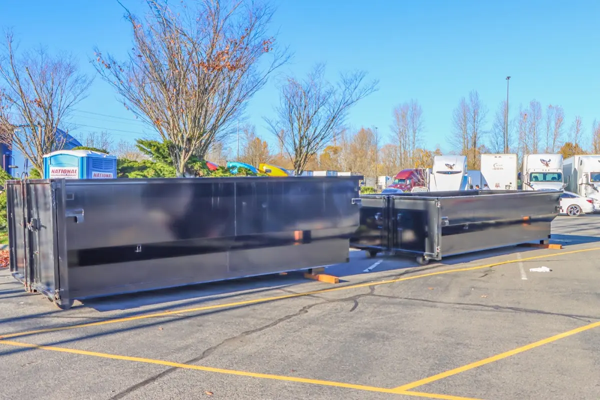 Professional dumpster rental service with roll-off container on residential driveway in Bermuda Dunes